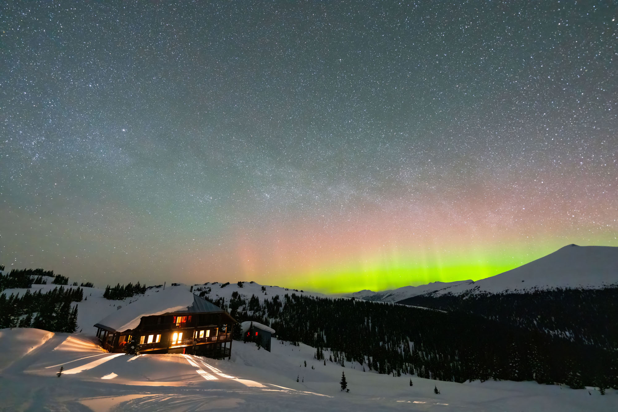 Northern lights over a guest cabin at Purcell Mountain Lodge